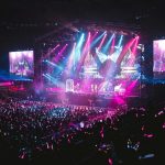 Colorful live concert with vibrant lighting, energetic crowd, and dynamic stage performance.