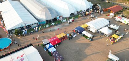 Aerial photo capturing an outdoor event with multiple tents in Maputo, Mozambique.