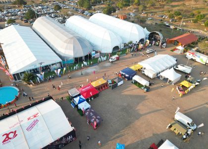 Aerial photo capturing an outdoor event with multiple tents in Maputo, Mozambique.